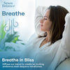 Woman relaxing with hands behind her head, promoting the use of Breathe Essential Oil Blend for diffusion and mindfulness.
