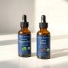 Nexon Botanics Organic Peppermint and Organic Clove Essential Oils set in amber glass dropper bottles.