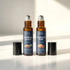 Two glass roll-on bottles of Nexon botanics Frankincense Castor Oil and Frankincense Myrrh 