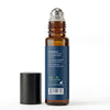 An amber glass rollerball bottle with a dark blue label and a silver cap, shown next to a separate black cap on a white background.