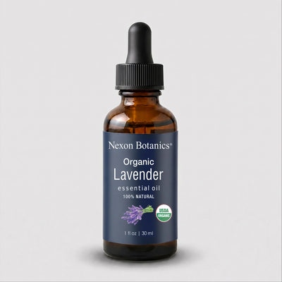 Nexon Botanics Organic Lavender essential oil in a 1 fl oz amber glass dropper bottle with a dark blue label and black dropper cap, shown on a light gray background.