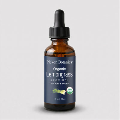 A 30 ml amber glass dropper bottle of Nexon Botanics Organic Lemongrass essential oil, featuring a dark blue label with white text and a black dropper cap, set against a light gray background.